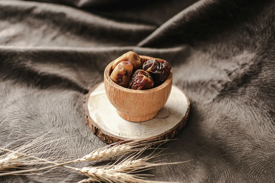 Dates in a small wooden bowl